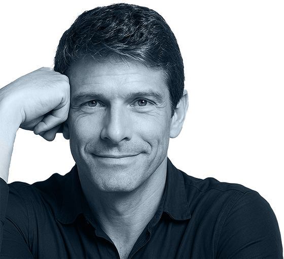 man resting on his hand smirking